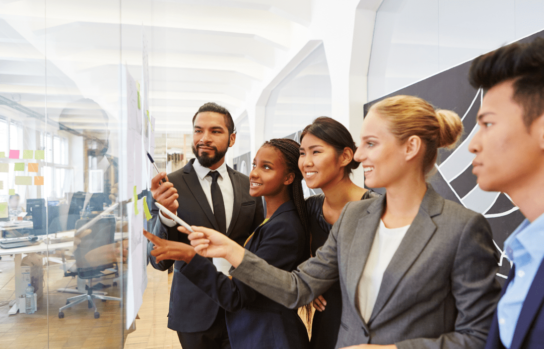 
                  A diverse group of consulting professionals collaborating and brainstorming around a glass wall covered with sticky notes,
                  symbolizing the comprehensive bookkeeping solutions provided by US-based, QuickBooks-certified teams for consulting firms.
                