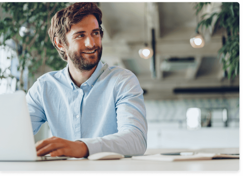 
                    Engaged male professional smiling and looking away from his laptop, symbolizing the impactful work environment
                    where helping companies thrive and creating value for clients is a daily pursuit.
                  
