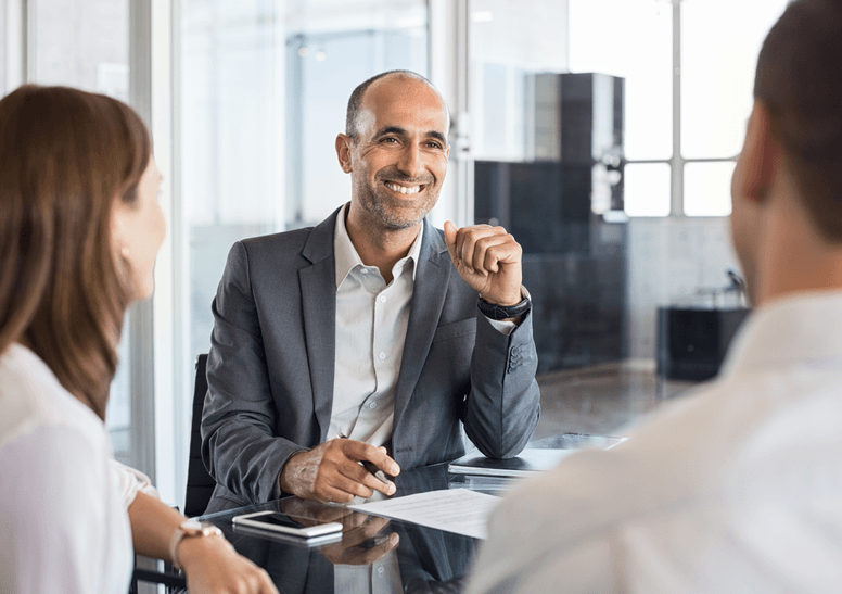 
                  Confident male executive in a meeting with colleagues, discussing important financial documents,
                  symbolizing the specialized accounting and bookkeeping services provided to private equity-backed firms by kept.pro.
                