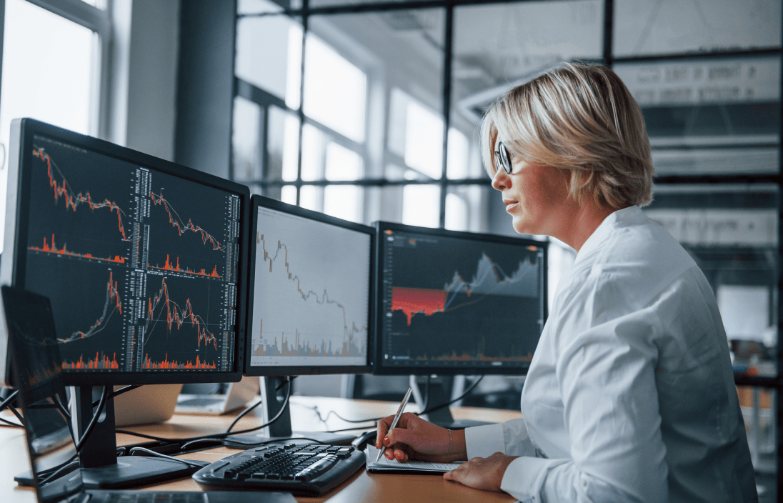 
                  Focused financial professional analyzing financial data across multiple computer monitors,
                  illustrating the detailed and expert bookkeeping services provided to private equity-backed firms.
                